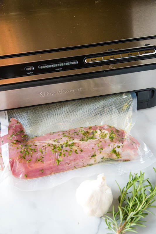 pork tenderloin in vacuum saver bag with rosemary and garlic