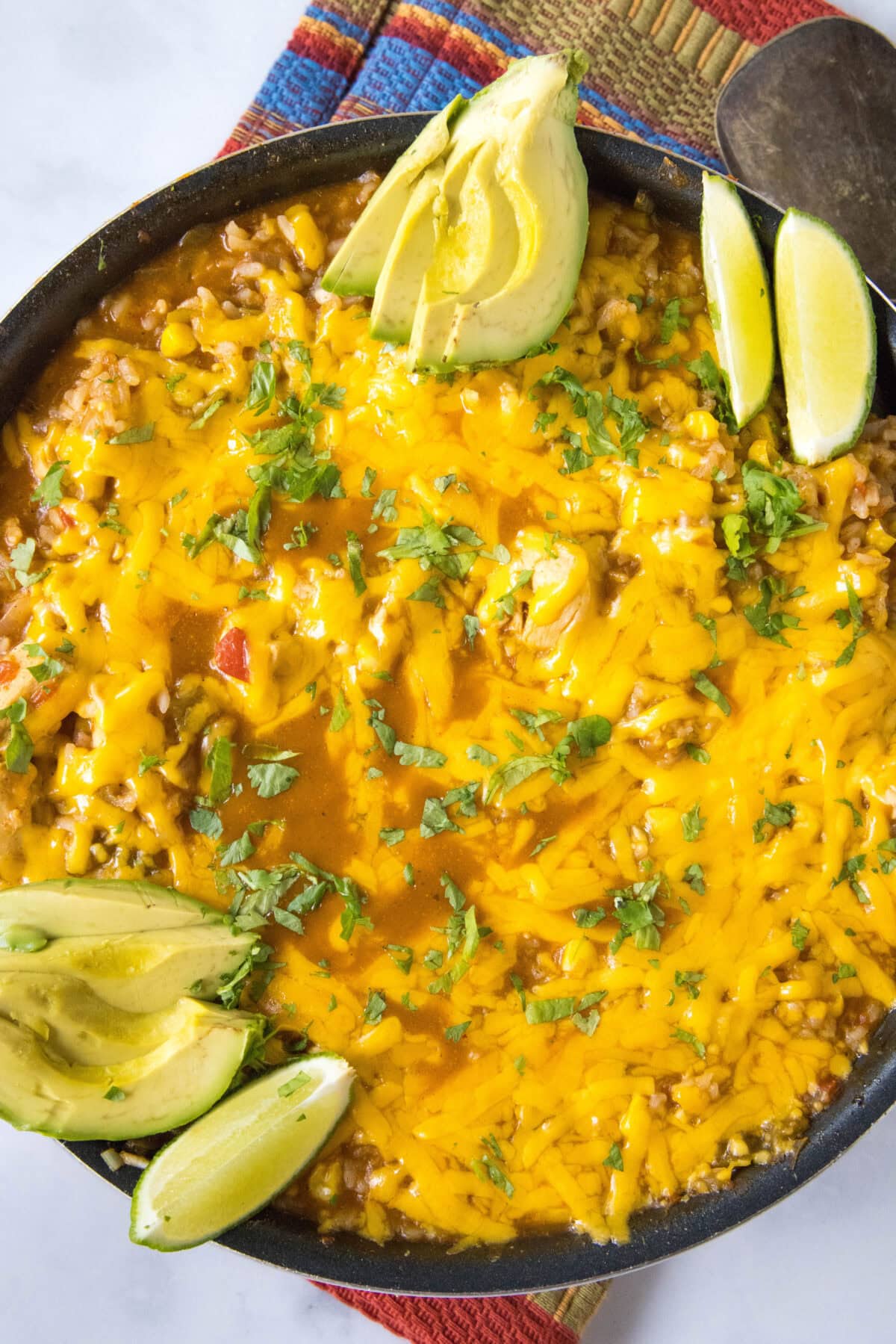 looking down on a southwest chicken skillet with avocado and cilantro