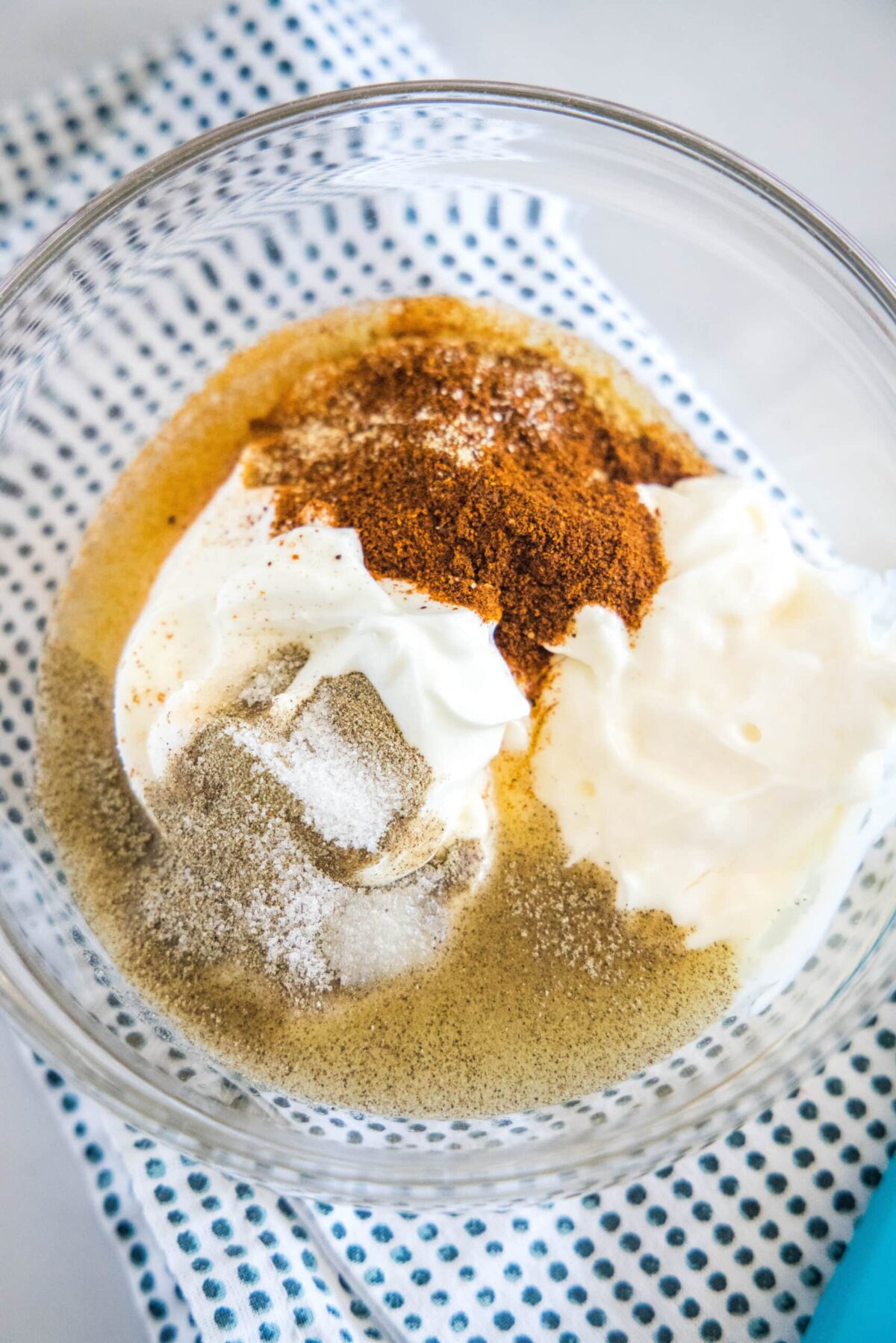 A mixing bowl with greek pogurt, mayo, lime juice, and spices