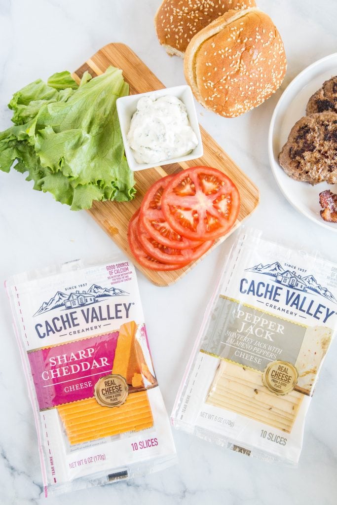 Bacon cheeseburgers with toppings and cheese