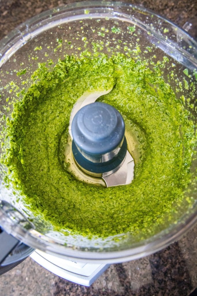 Overhead view of pesto in a food processor