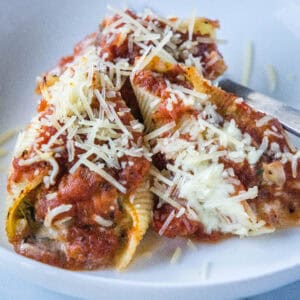 cropped close up spinach stuffed shells on a white plate