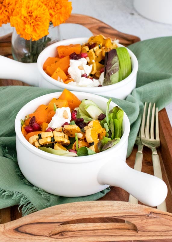 2 bowls of goat cheese salad on tray