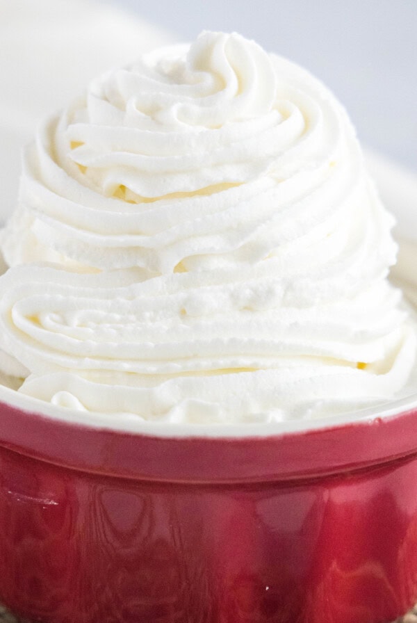 Close up of a ramekin full of stabilized whipped cream
