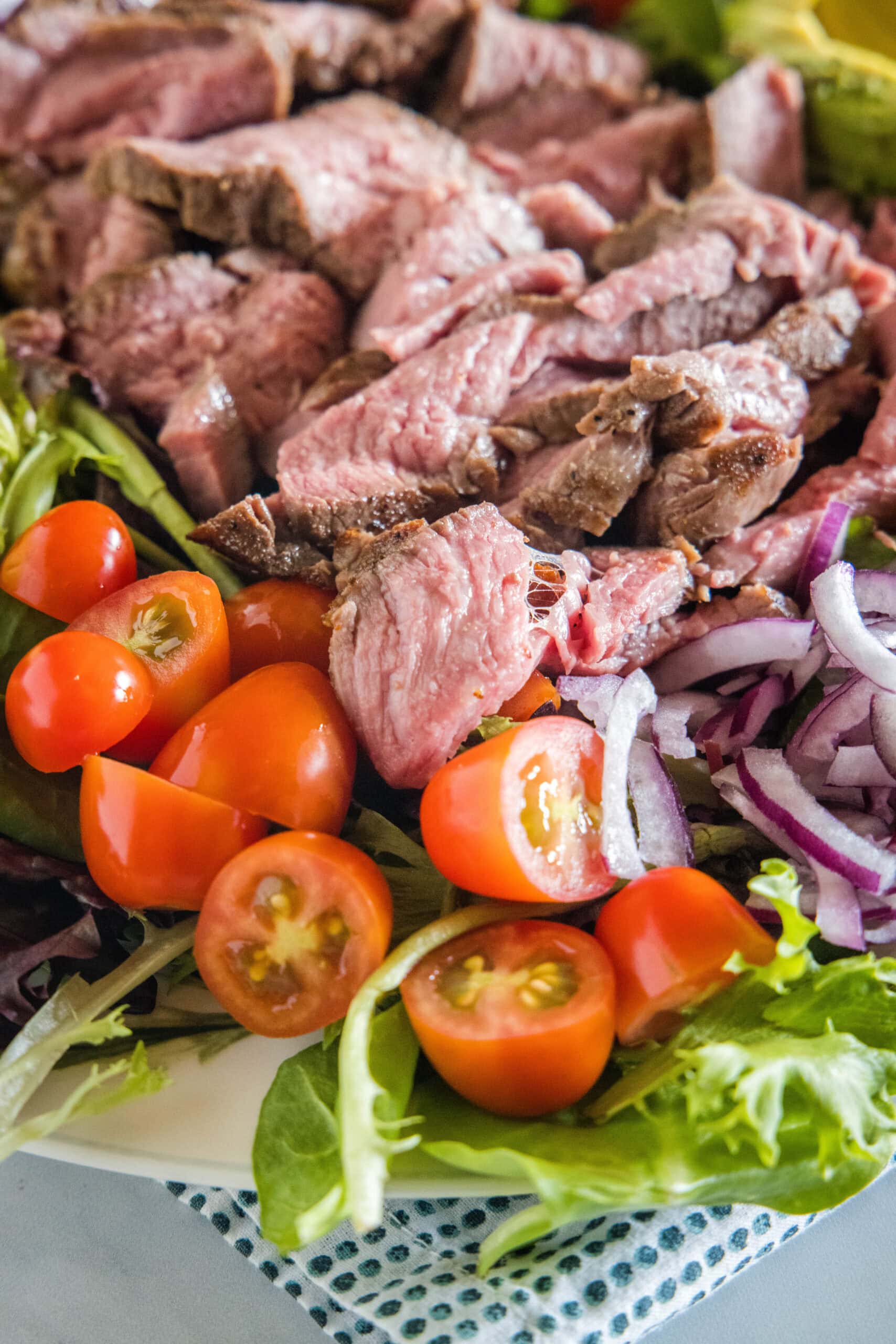 Close up of steak salad on a large platter.