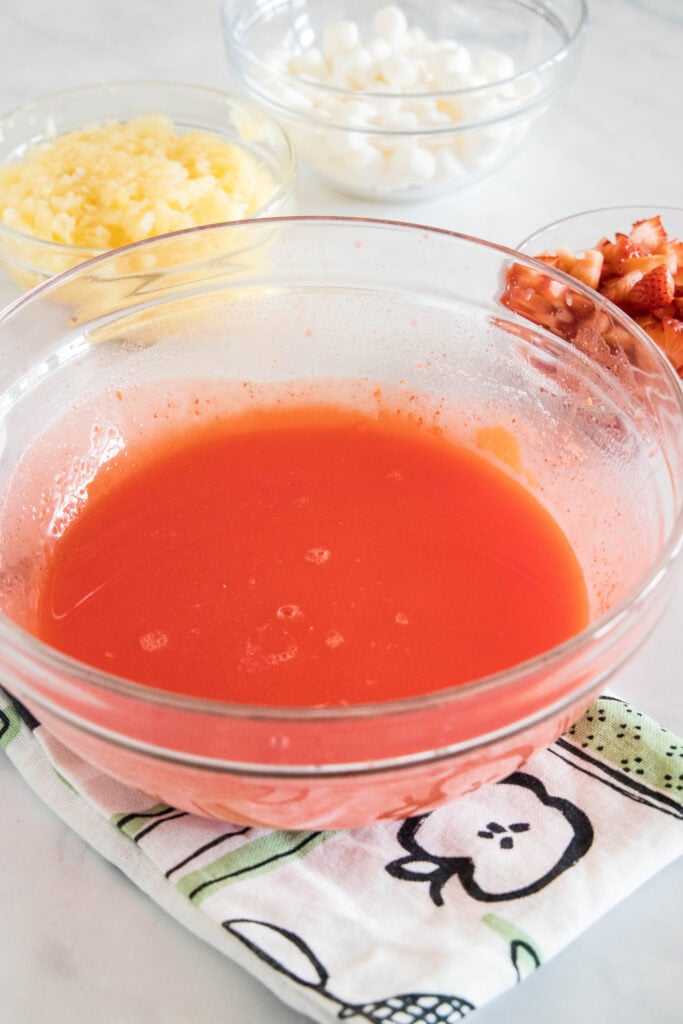 Strawberry jello in a glass bowl.