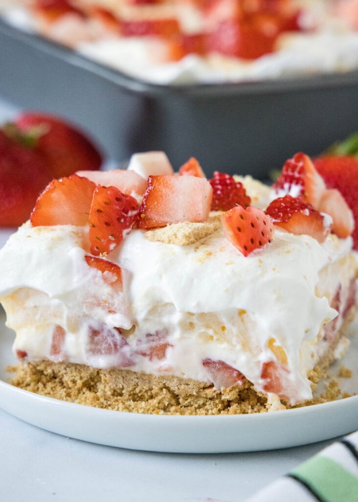 a slice of strawberry lush squares on a plate
