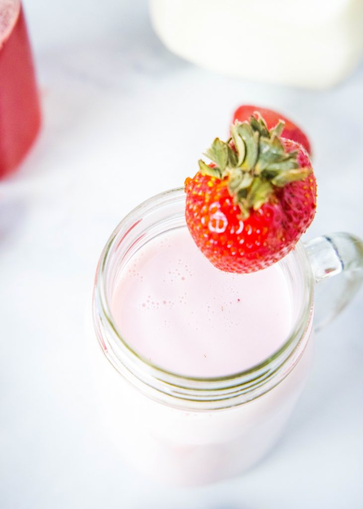 looking down on a cup of strawberry milk