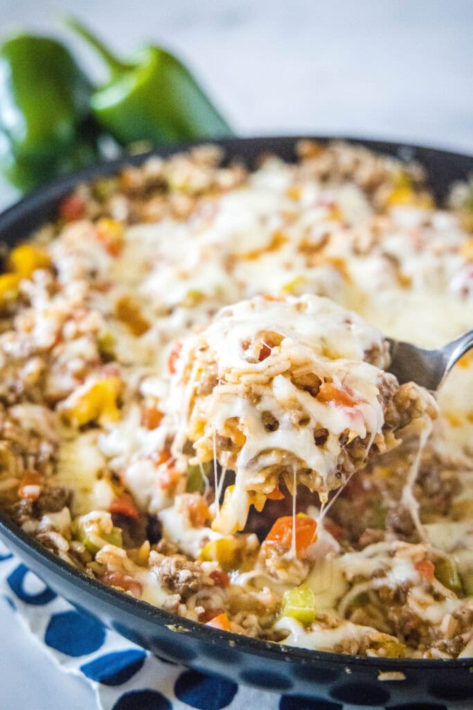 spooning out casserole from a skillet