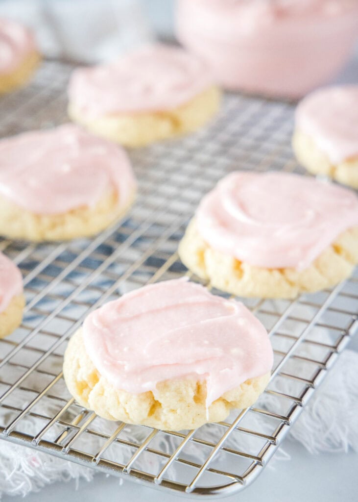 frosted sugar cookies on a cooling rack
