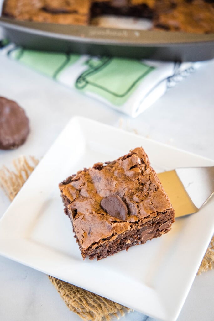 brownie with thin mints on a white plate