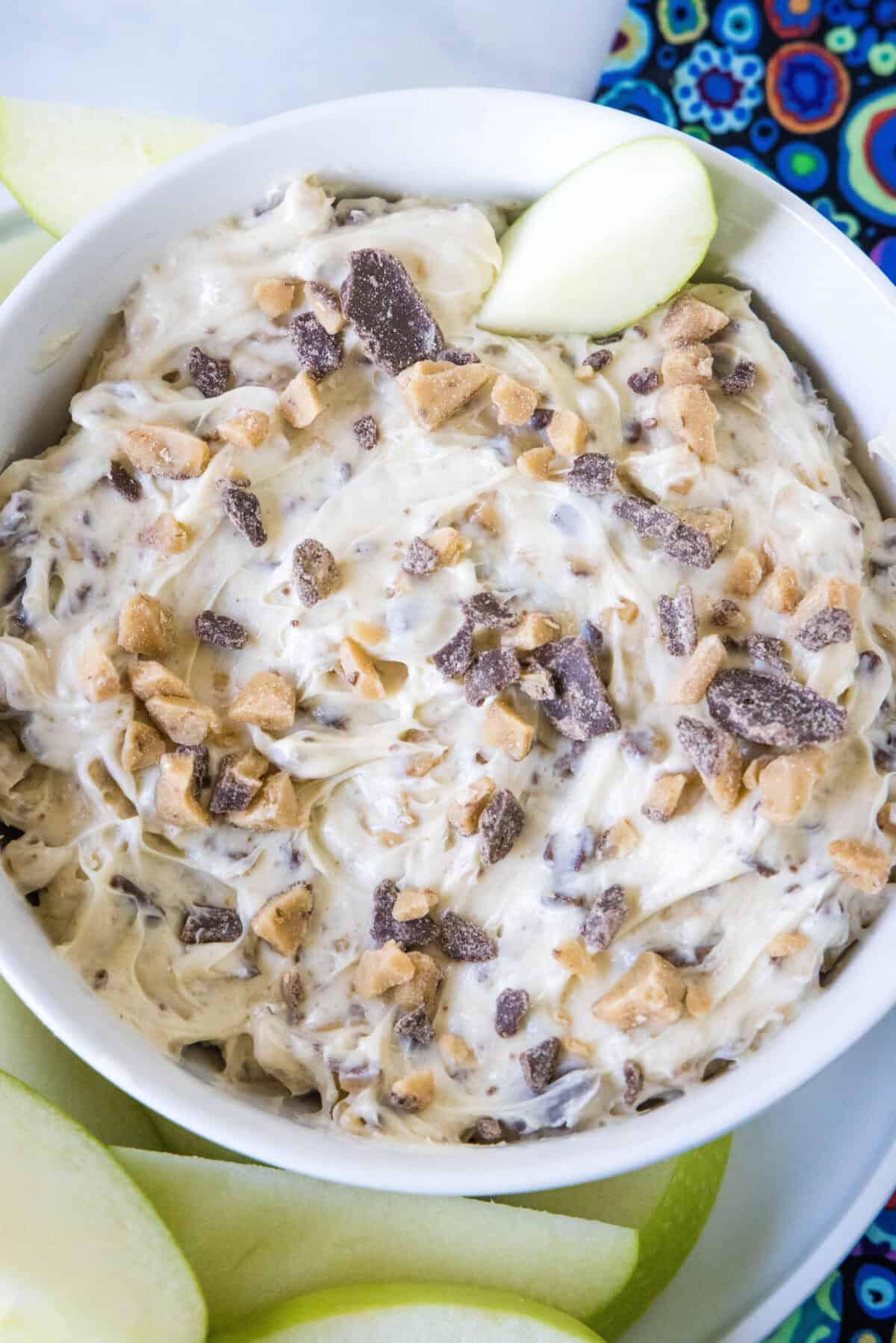 looking down in a serving bowl of toffee apple dip with apples
