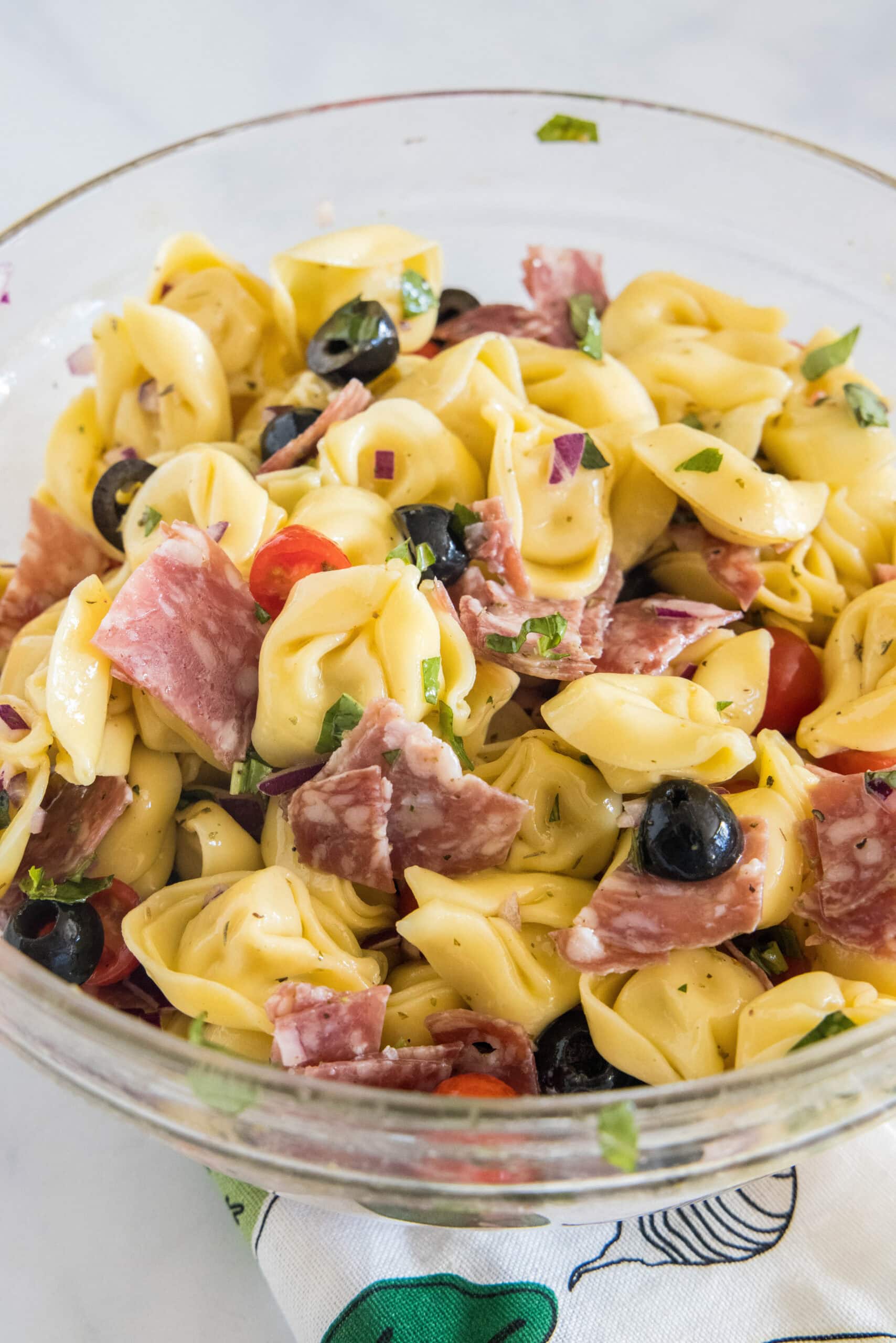 Tortellini pasta salad in a glass bowl.