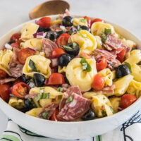 Tortellini pasta salad in a white bowl.