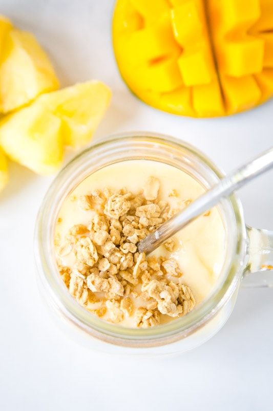 close up of smoothie in a glass with granola on top