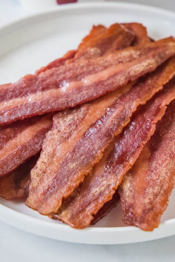 cropped close up cooked turkey bacon on a white plate