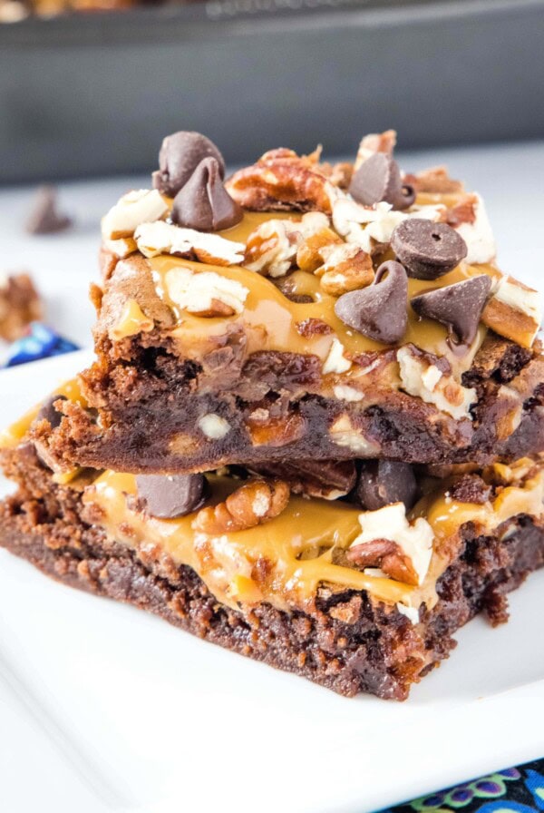 close up stacked brownies with pecans and caramel