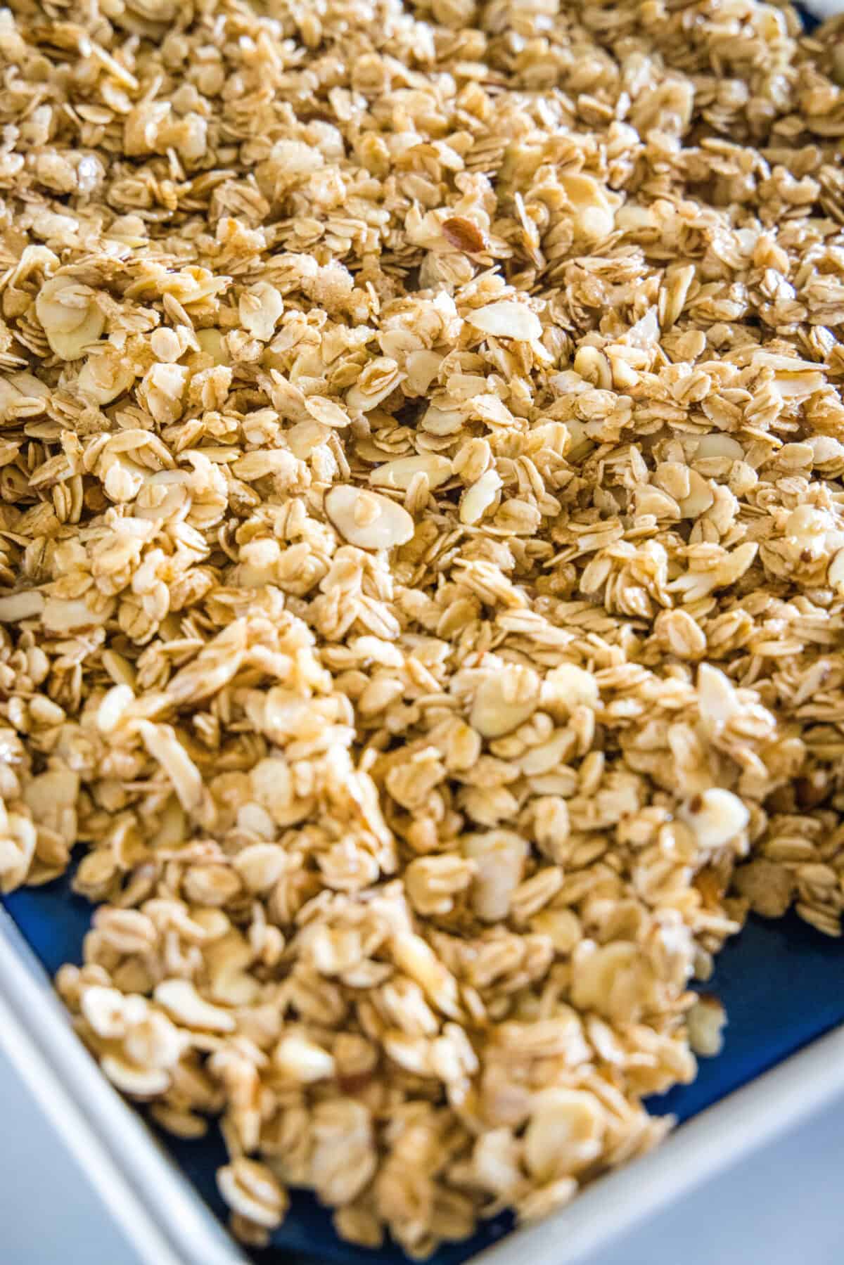 granola on a baking sheet ready for the oven