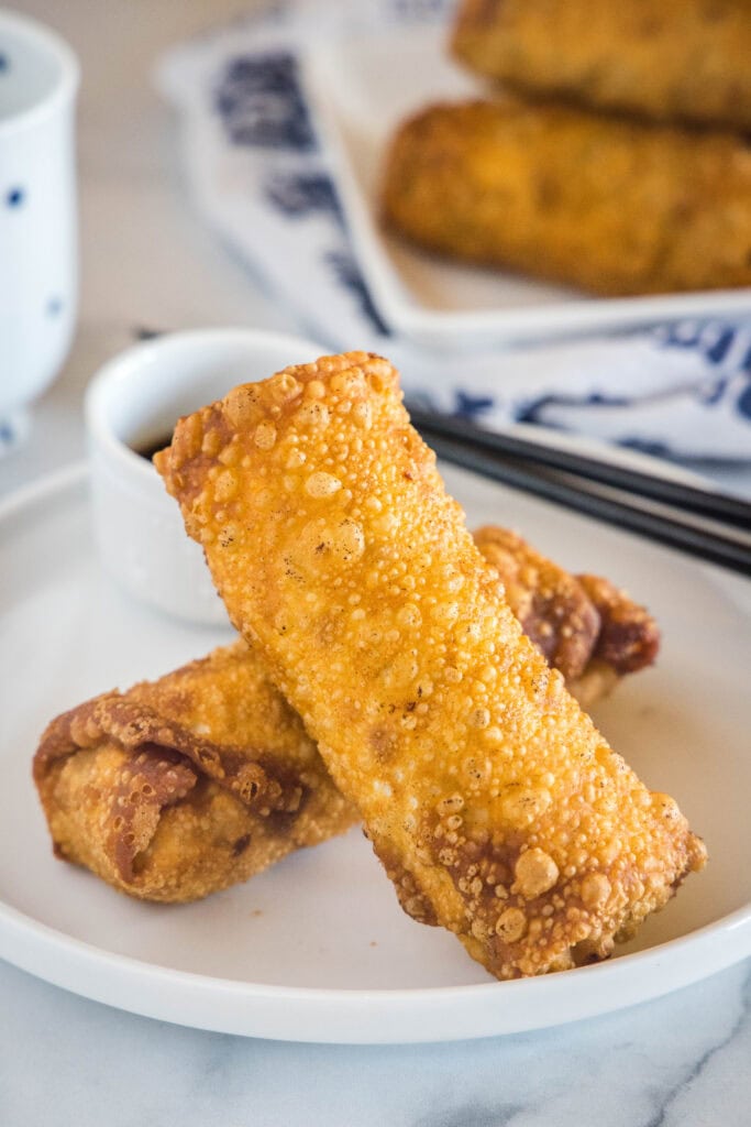 2 vietnamese egg rolls on a white plate