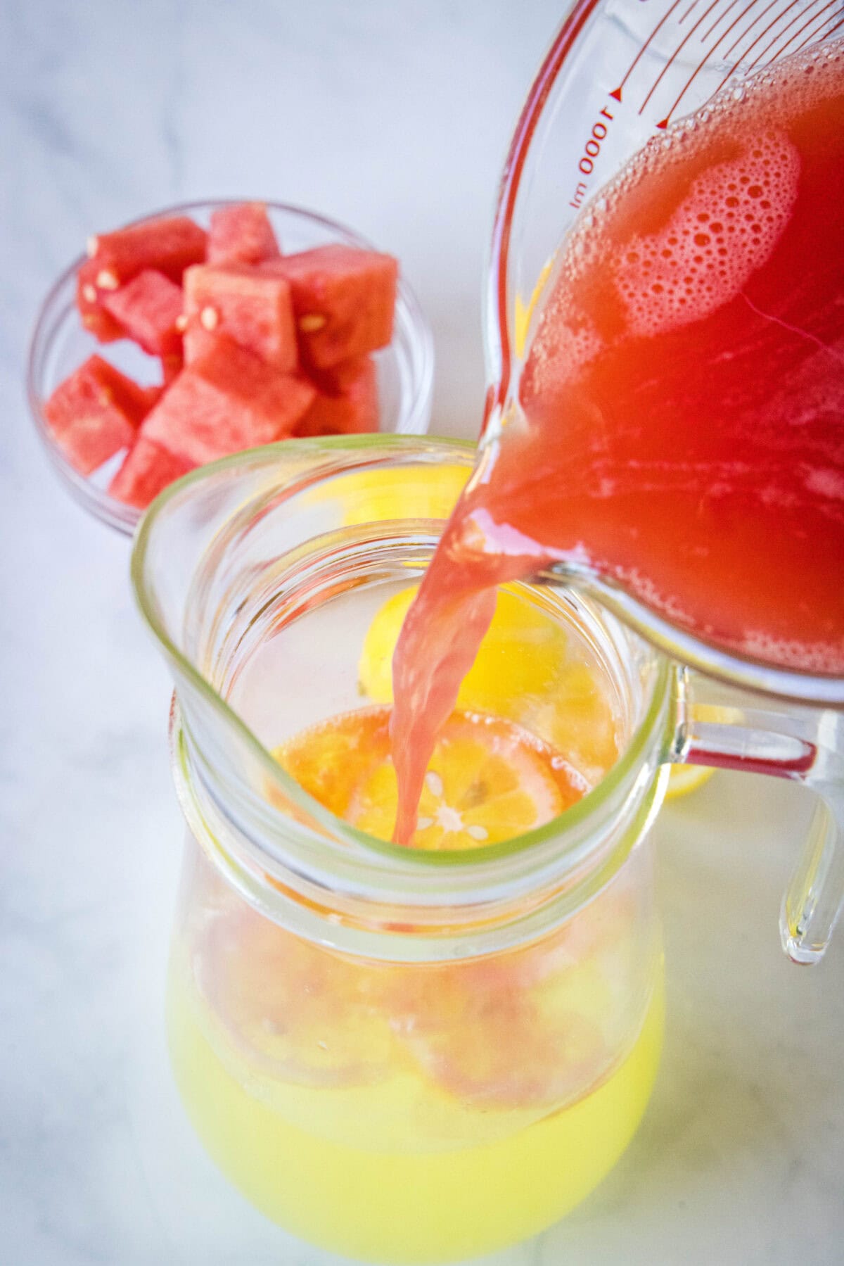 adding watermelon juice to lemonade