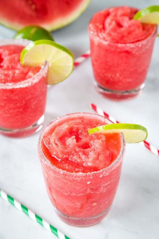 homemade watermelon flavored margaritas in glasses with slices of lime