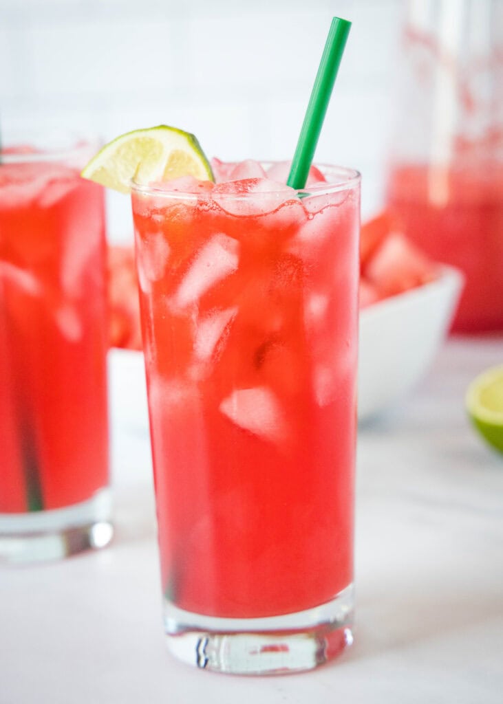 a glass filled with watermelon soda and a straw