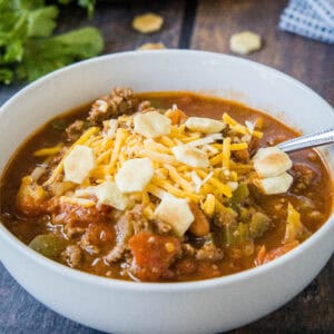cropped close up bow of chili with cheese and crackers