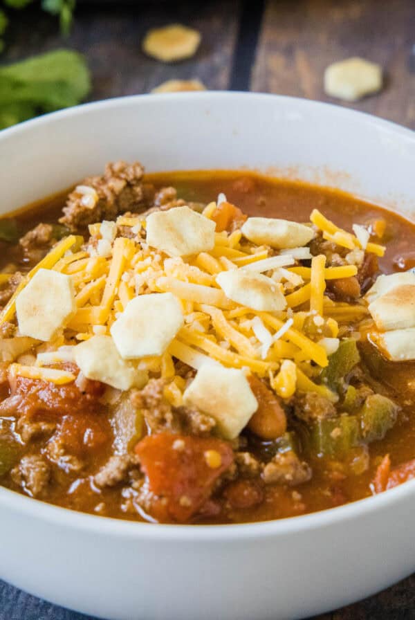 cropped close up bow of chili with cheese and crackers