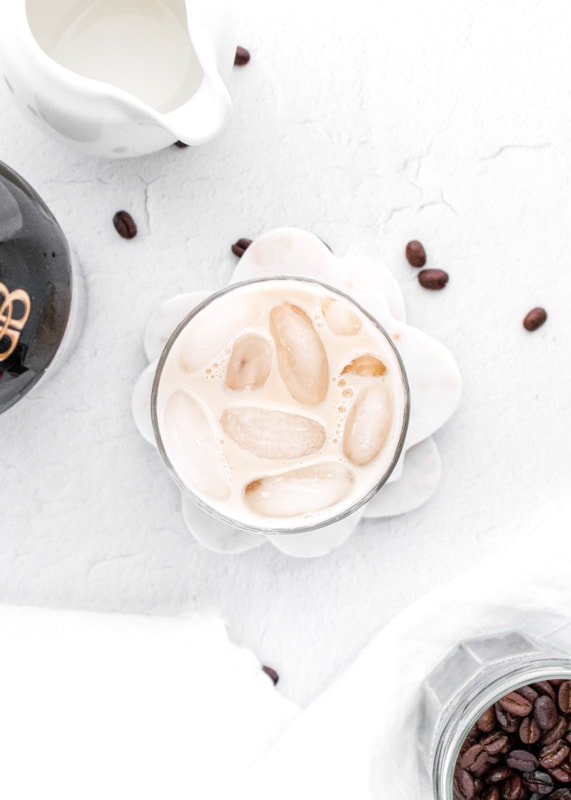 looking down a glass filled with a baileys white russian cocktail