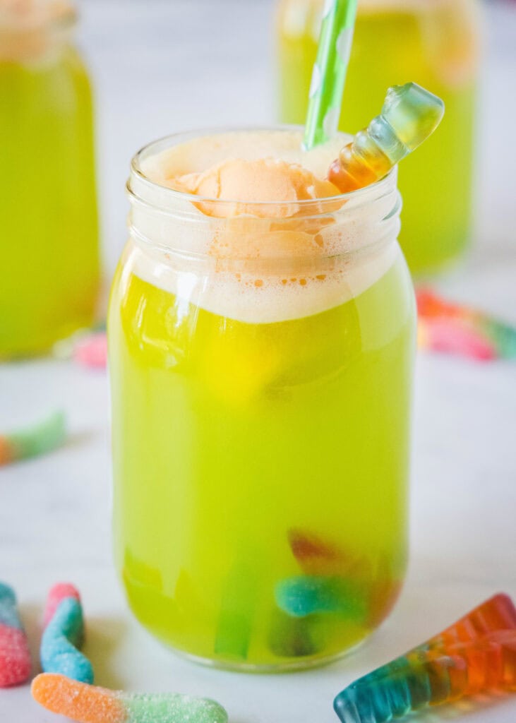 fun green halloween drink for kids with orange sherbet