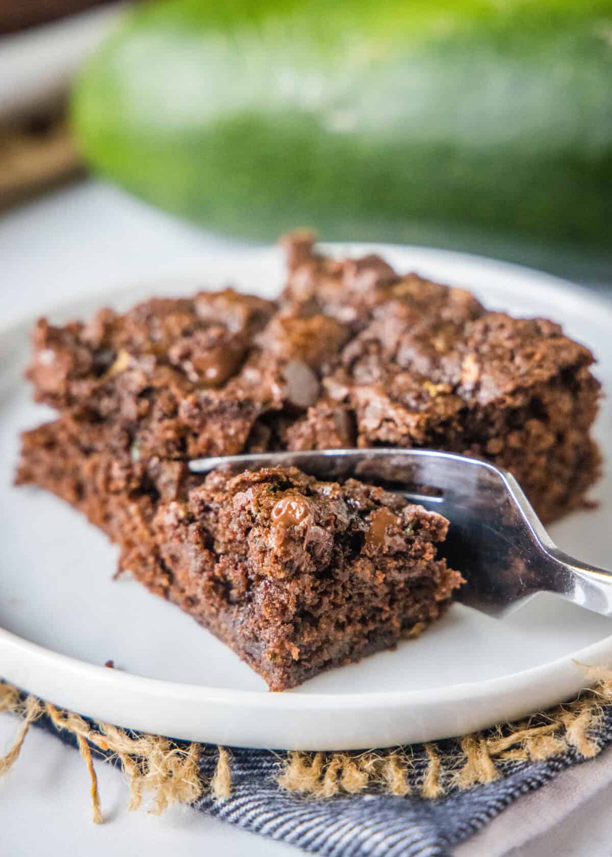 a fork cutting a bite out of a brownie