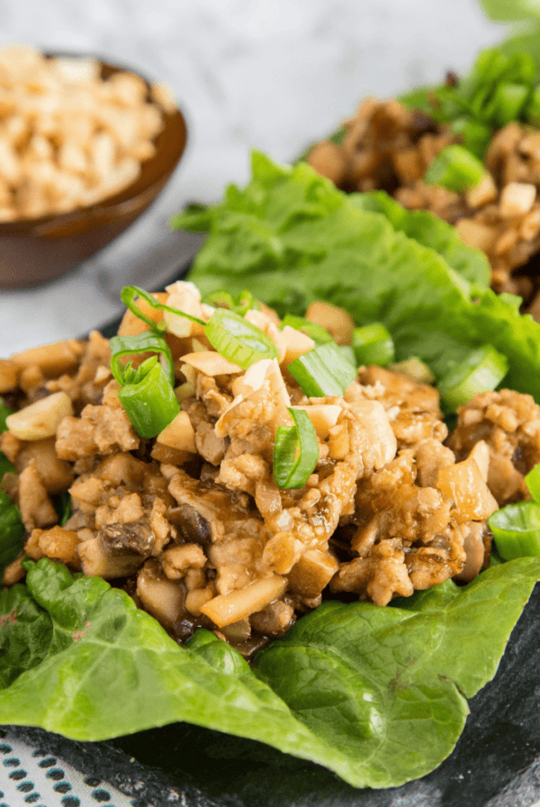 A plate of food, with chicken lettuce wraps
